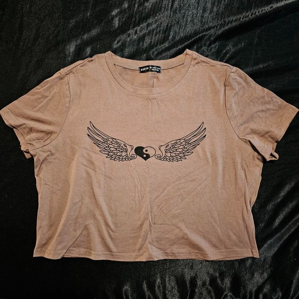 cool toned tan/brown greige crop top with black yin yang heart wings